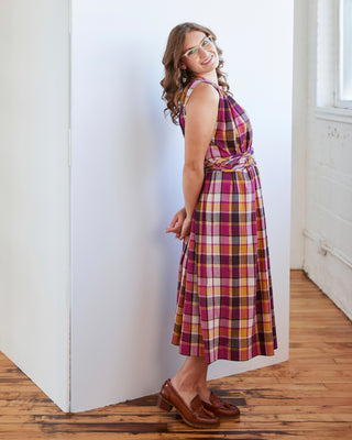 Woman wearing a plaid dress standing against a white wall. This dress is the Rockwell Dress sewing pattern from Cashmerette.