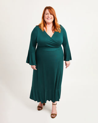 Woman wearing a green dress on a white background. This dress is the Alcott Dress sewing pattern from Cashmerette.