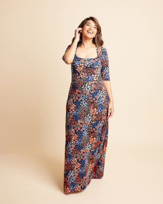 Woman wearing a floral dress on a beige background. This is the Grafton Dress, Top & Skirt sewing pattern from Cashmrette.