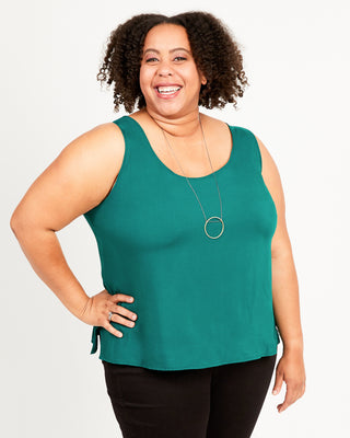 Woman wearing a green sleeveless top against a white background. This top is the Springfield Top sewing pattern from Cashmerette.