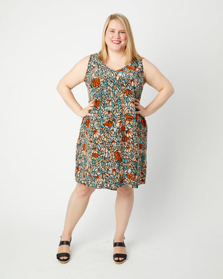 Woman wearing a floral dress on a white background. This dress is the Webster Dress & Tunic sewing pattern from Cashmerette.