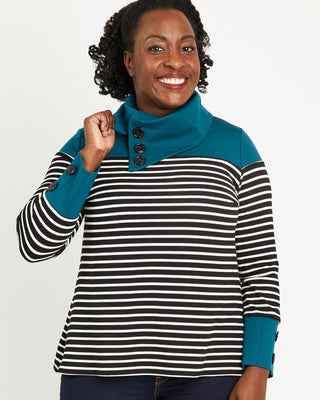 Woman wearing a striped sweater with a teal collar against a plain background. This sweater is the Tobin Sweater sewing pattern from Cashmerette.