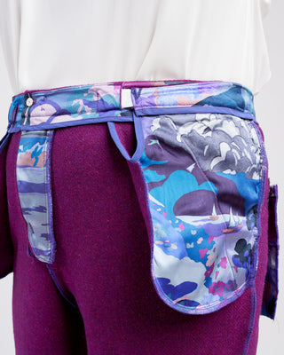 Purple pants worn inside out with colorful designs on a white background. These pants are the Meriam Trousers sewing pattern from Cashmerette.