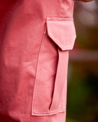 Close-up of a pink pocket on a garment with a blurred background. These pants are the Esmond Cargo Pants sewing pattern from Cashmerette.
