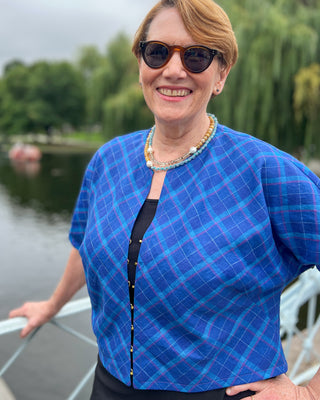 Woman wearing a blue checkered jacket by a body of water.  This jacket is the Catskills Bias Jacket sewing pattern from Cashmerette.