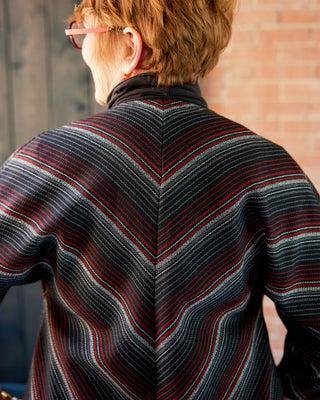 Person wearing a striped sweater with a brick wall background. This jacket is the Catskills Bias Jacket sewing pattern from Cashmerette.