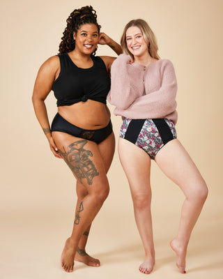 Two women standing side by side wearing underwear on a beige background. These undies are the Radcliffe Undies sewing pattern from Cashmerette.