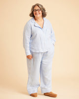Person wearing a light blue pajama set on a beige background. This is the Fiske Sleepwear Set sewing pattern from Cashmerette.