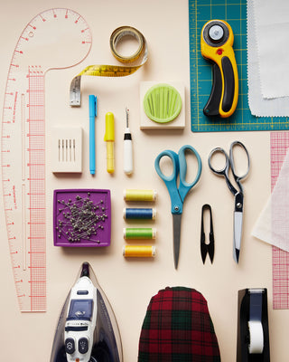 Collection of sewing and crafting tools on a flat surface