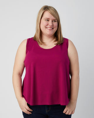 Woman wearing a pink sleeveless top against a plain background. This is a pattern hack of the Springfield Top from the Pattern Hacking for Curves class.