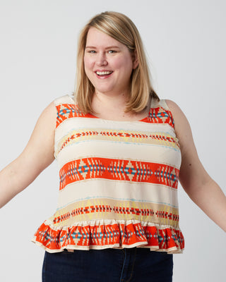 Woman wearing a sleeveless top with a colorful pattern on a plain background. This is a pattern hack of the Springfield Top from the Pattern Hacking for Curves class.