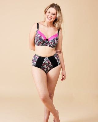 Woman wearing a floral lingerie set on a beige background. These undies are the Radcliffe Undies sewing pattern from Cashmerette.