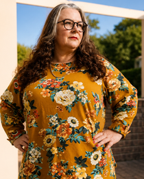 Woman wearing a yellow top with a floral print. This is the Wellfleet T-Shirt sewing pattern from Cashmerette.