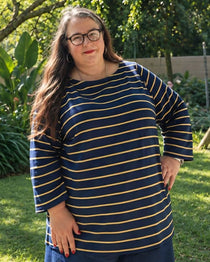 Woman wearing a navy and yellow striped shirt. This is the Wellfleet T-Shirt sewing pattern from Cashmerette.