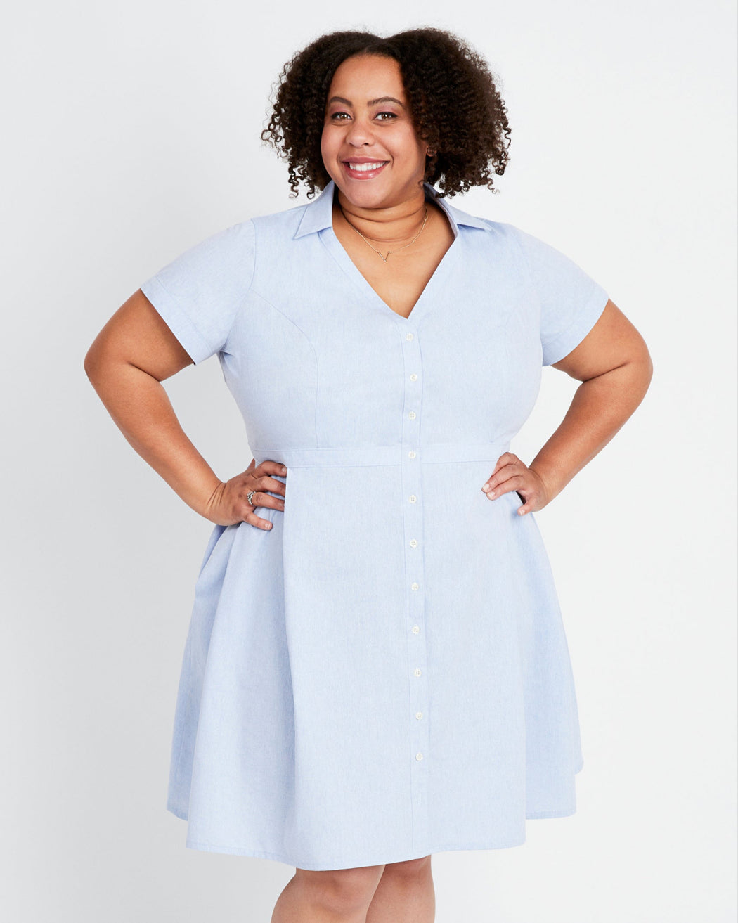 Woman wearing a light blue dress against a white background. This dress is the Lenox Shirtdress sewing pattern from Cashmerette.