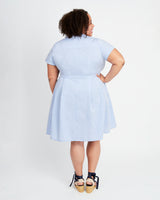 Woman wearing a light blue dress against a white background. This dress is the Lenox Shirtdress sewing pattern from Cashmerette.