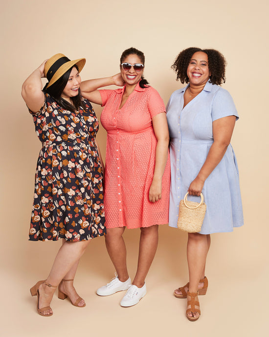 Three women wearing dresses in different colors posing against a beige background. This dress is the Lenox Shirtdress sewing pattern from Cashmerette.