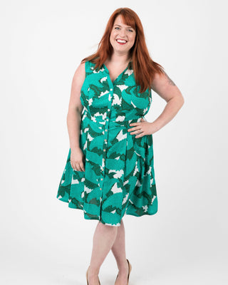 Woman wearing a green dress with white patterns on a white background. This dress is the Lenox Shirtdress sewing pattern from Cashmerette.