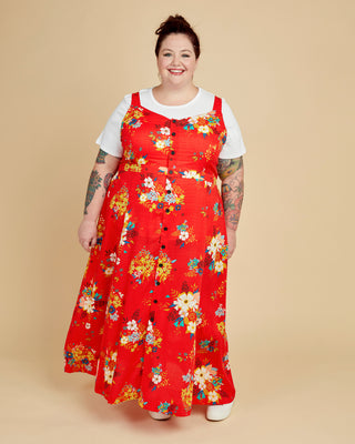 Person wearing a red floral dress on a beige background. This is the Holyoke Maxi Dress & Skirt sewing pattern from Cashmerette.