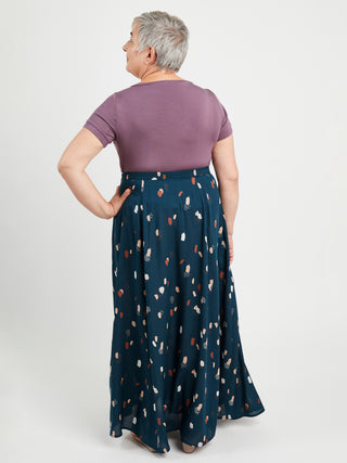 Woman wearing a purple top and blue patterned skirt on a white background. This is the Holyoke Maxi Dress & Skirt sewing pattern from Cashmerette.