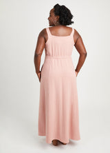 Woman wearing a pink sleeveless dress on a white background. This is the Holyoke Maxi Dress & Skirt sewing pattern from Cashmerette.
