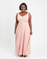 Woman wearing a pink sleeveless dress with buttons on a white background. This is the Holyoke Maxi Dress & Skirt sewing pattern from Cashmerette.