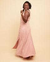 Woman wearing a pink dress against a beige background. This is the Holyoke Maxi Dress & Skirt sewing pattern from Cashmerette.