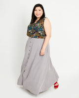 Woman wearing a floral top and gray skirt on a white background. This is the Holyoke Maxi Dress & Skirt sewing pattern from Cashmerette.