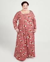 Woman wearing a pink floral dress on a white background. This dress is the Upton Dress & Skirt sewing pattern from Cashmerette.