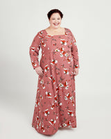 Woman wearing a floral dress on a white background. This dress is the Upton Dress & Skirt sewing pattern from Cashmerette.
