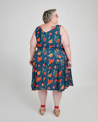 Woman wearing a blue floral dress on a white background. This dress is the Upton Dress & Skirt sewing pattern from Cashmerette.