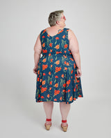 Woman wearing a blue floral dress on a white background. This dress is the Upton Dress & Skirt sewing pattern from Cashmerette.