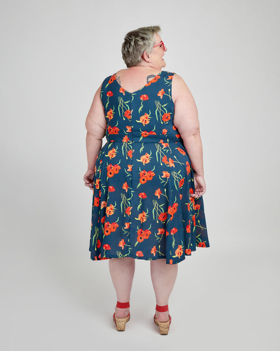Woman wearing a blue floral dress on a white background. This dress is the Upton Dress & Skirt sewing pattern from Cashmerette.