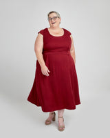 Woman wearing a red dress on a white background. This dress is the Upton Dress & Skirt sewing pattern from Cashmerette.