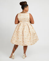 Woman wearing a beige floral dress on a white background. This dress is the Upton Dress & Skirt sewing pattern from Cashmerette.