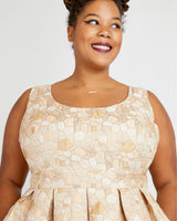 Woman wearing a beige patterned dress against a plain background. This dress is the Upton Dress & Skirt sewing pattern from Cashmerette.