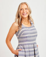 Woman wearing a blue and white striped dress against a plain background. This dress is the Upton Dress & Skirt sewing pattern from Cashmerette.