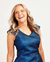 Woman wearing a blue dress with a plain background. This dress is the Upton Dress & Skirt sewing pattern from Cashmerette.
