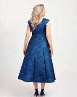 Woman wearing a blue lace dress on a white background. This dress is the Upton Dress & Skirt sewing pattern from Cashmerette.