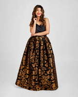 Woman wearing a black top and leopard print skirt on a white background. This skirt is the Upton Dress & Skirt sewing pattern from Cashmerette.
