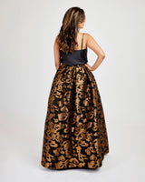 Woman wearing a black top and leopard print skirt on a white background. This skirt is the Upton Dress & Skirt sewing pattern from Cashmerette.