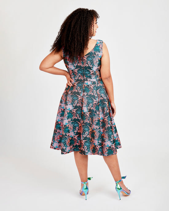 Woman wearing a floral dress on a white background. This dress is the Upton Dress & Skirt sewing pattern from Cashmerette.