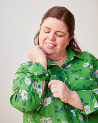 Woman wearing a green floral blouse against a plain background. This dress is the Winvale Dress & Tunic sewing pattern from Cashmerette.