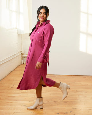 Woman wearing a pink dress with long sleeves in a bright room. This dress is the Winvale Dress & Tunic sewing pattern from Cashmerette.