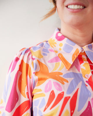 Person wearing a colorful patterned shirt with a plain background. This dress is the Winvale Dress & Tunic sewing pattern from Cashmerette.