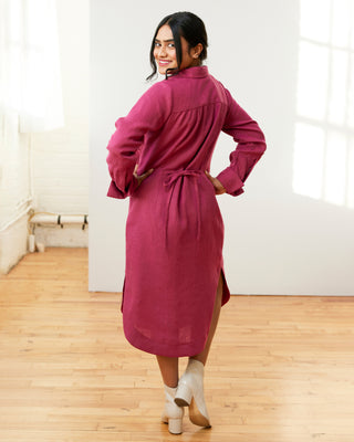 Woman wearing a magenta dress standing in a room with wooden floor and white walls. This dress is the Winvale Dress & Tunic sewing pattern from Cashmerette.