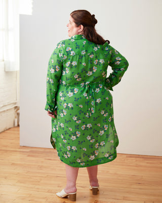Woman wearing a green floral dress in a minimal indoor setting. This dress is the Winvale Dress & Tunic sewing pattern from Cashmerette.