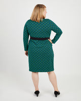 Woman wearing a green patterned dress on a white background. This dress is the Appleton Wrap Dress sewing pattern from Cashmerette.
