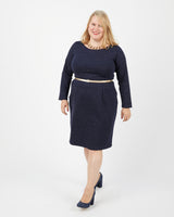 Woman wearing a navy blue outfit with a white background. This dress is the Rivermont Dress & Top sewing pattern from Cashmerette.