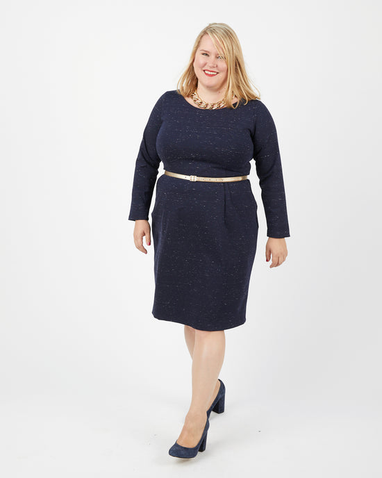 Woman wearing a navy blue outfit with a white background. This dress is the Rivermont Dress & Top sewing pattern from Cashmerette.